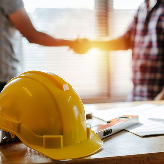 Construction workers shaking hands